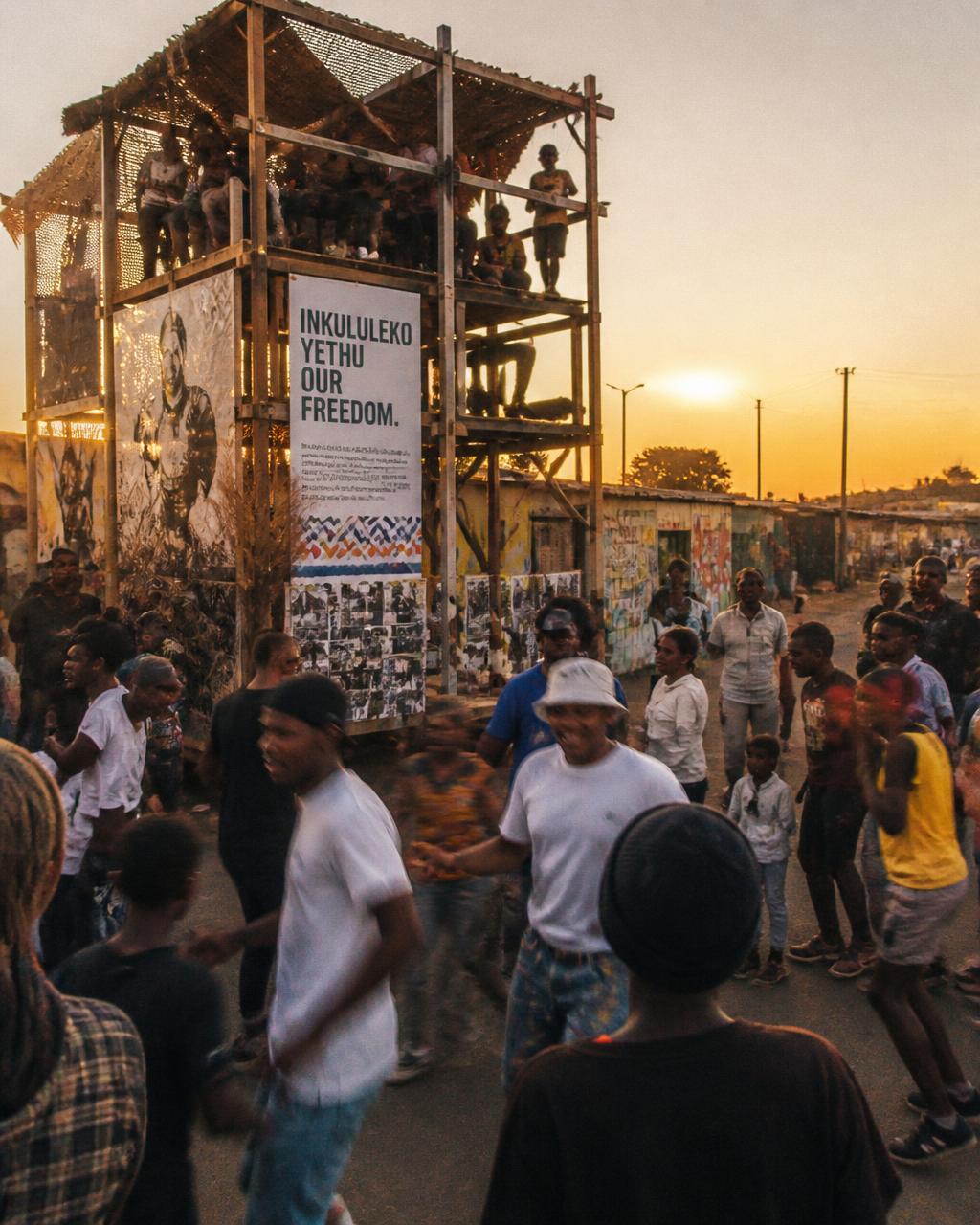 People of all ages gathered for a community activation at sunset